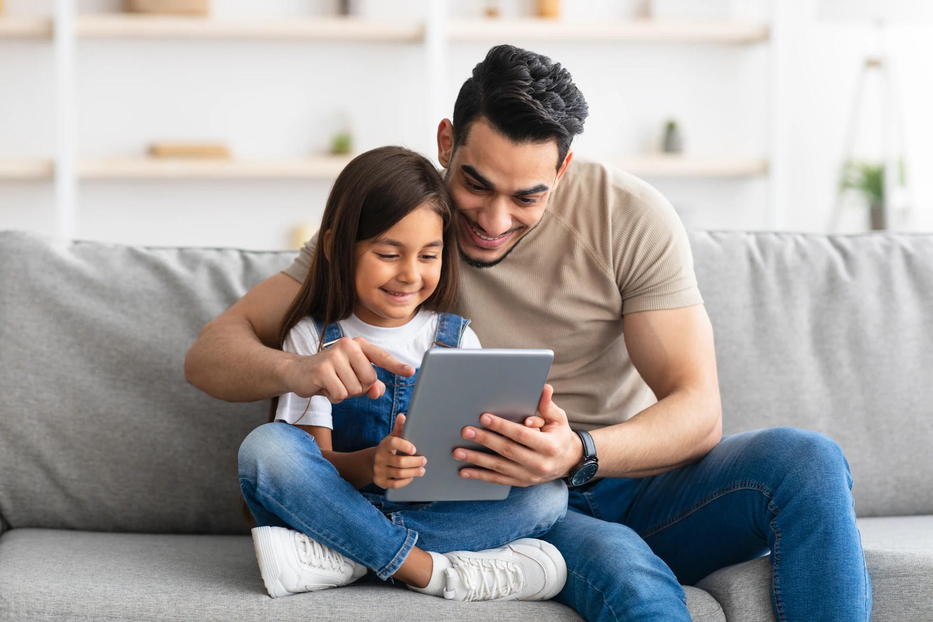 Father and Daughter Looking at Tablet